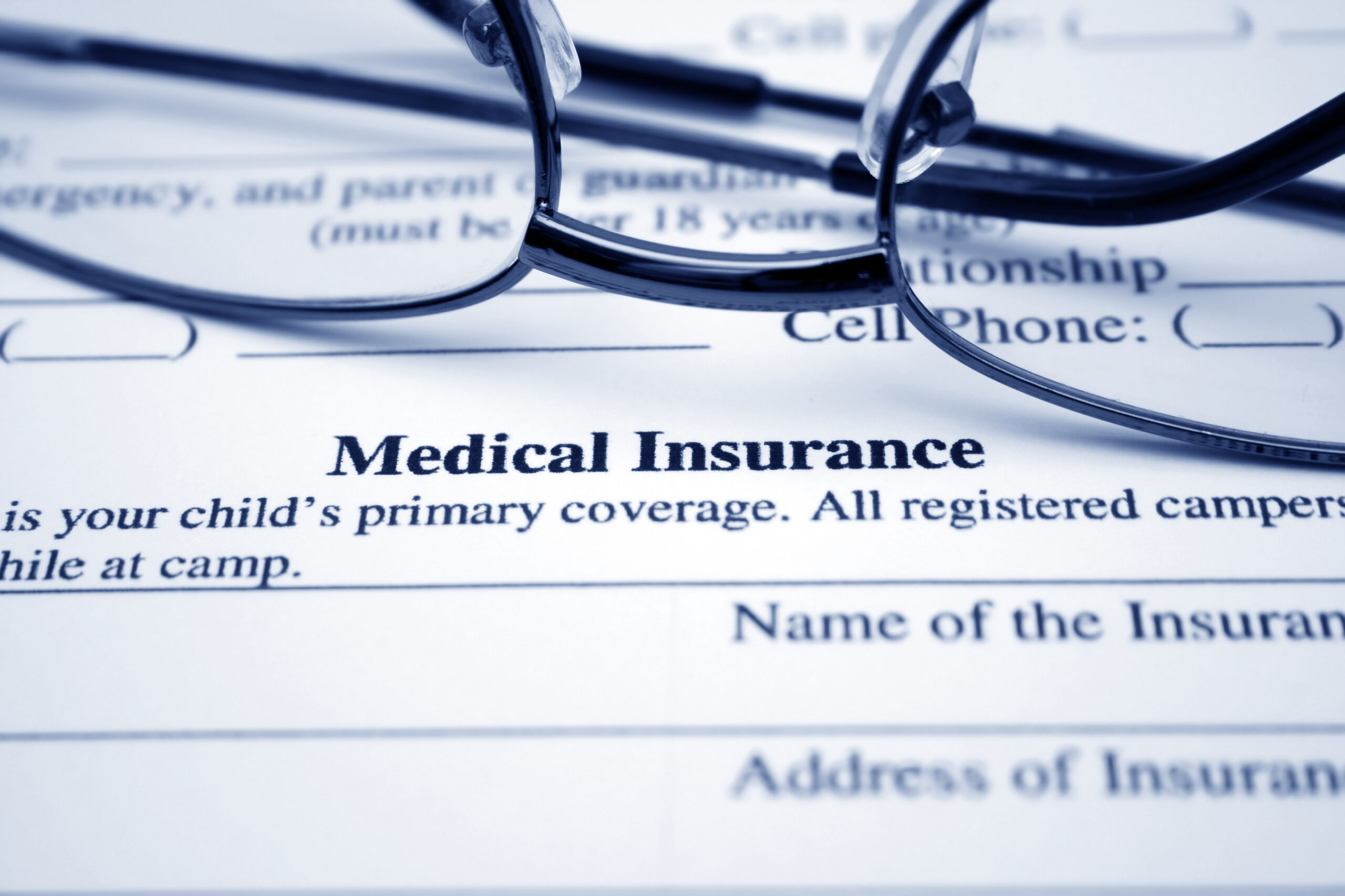 Image of glasses setting on medical insurance paperwork