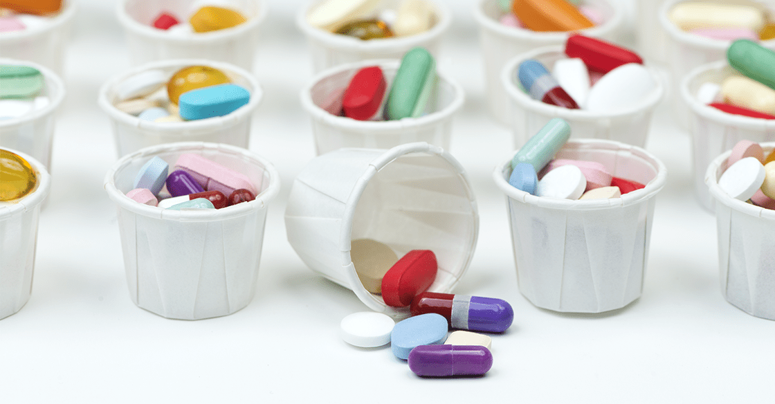 Rows and colums of little paper cups filled with pills to illustrate Medications to Avoid After Gastric Sleeve Surgery
